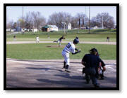 A baseball player running to bat